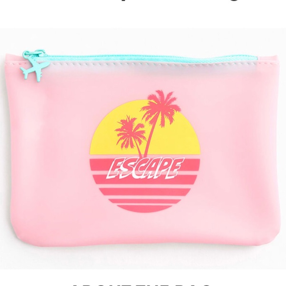 Pale pink escape makeup bag with palm trees and turquoise airplane zipper pull